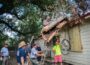 Volunteers from New Sharon Fire and Biloxi, Mississippi work to remove a tree from a home in Louisiana.