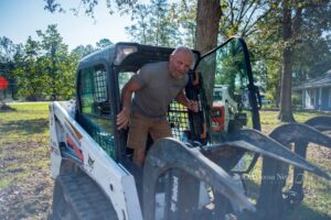 David Letourneau seen here climbing out of his skid-steer while helping New Sharon Fire and other volunteers clean up yards.