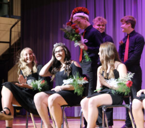 Morgan Hudson received the crown from king Sean Knockel as North Mahaska began its homecoming celebration Thursday. Also pictured, Layla Hargis, left and Kaitlyn VanDonselaar in front row. In back behind Knockel, Sam Terpstra and Jaydyn Steil.