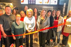 Cara Van Steenis gets ready to cut the ribbon on her new McDonalds restaurant in Oskaloosa.