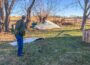 Rural Mahaska County resident Kenneth Mortensen survey's what's left of his roof that was blown off during a derecho on Wednesday evening.