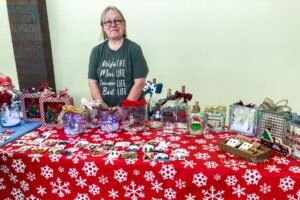Jeri Housholder sells her handcrafted gifts during the final vendor show at Penn Central Mall before Christmas.