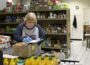A volunteer goes over food supplies at the Urbandale Food Pantry. (Photo courtesy of UFP)