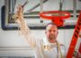 William Penn Men's Basketball Head Coach John Henry holds the net from the team's sixth in seven years conference championship.