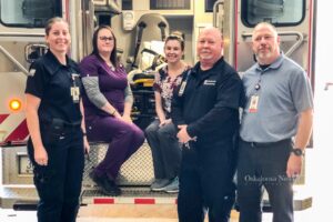 Emergency room staff from Mahaska Health pose with one of their ambulance's. (Mike Lang far right)