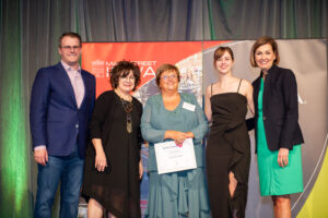 Oskaloosa Main Street recognized Vicky Collette (Center)for the Volunteer of the Year Leadership Award. Vicky serves on the Oskaloosa Main Street Design Committee and spearheaded the Christmas Window StoryWalk®.