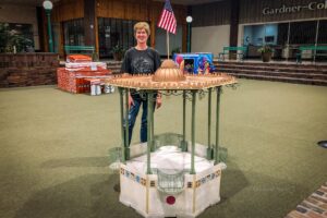 Cyndi Fynaardt with the replica of the Oskaloosa Bandstand.