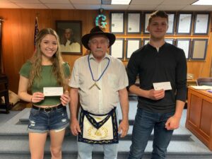 Mahaska Lodge 644 masonic lodge awarded two $1000 scholorships to student that have a family relation to members of Mahaska Lodge. Those receiving scholorships are Attalay Teeter and Hayden Nienkerk. Attalay is the daughter of member Dustin M Teeter. Hayden Nienkerk is the grandson of member James R Barnett. The pictures shows Master Mahaska Lodge 644 Miles Sabin presenting the checks to Attalay Teeter and Hayden Nienkerk 