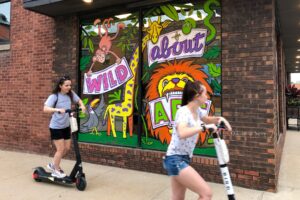 A couple of people enjoying the e-scooters by Bird. (file photo)