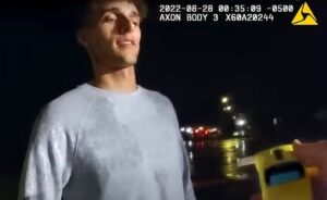 Police body-camera footage shows Tayvin Galanakis being read his rights and arrested seconds after a roadside breath test showed he had no alcohol in his system. (Screenshot of YouTube video sourced from the Newton Police Department)
