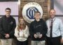 Optimist Club of Oskaloosa honored two seventh grade students Wednesday as the Students of the Trimester. Club Members Clint Gingrich, left and Mark Scholes, far right, presented the plaques to Lauren McKain and Edward Rust.