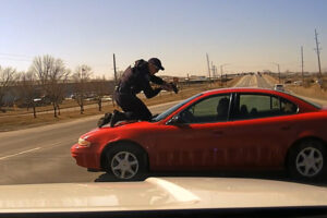 Carroll Police Officer Patrick McCarty stepped onto the hood of a moving car in an attempt to stop a fleeing driver in March 2021. (Screenshot of police dash camera video)
