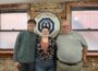 Oskaloosa Optimist president, R.D. Keep, right, presented Oskaloosa seniors Elliott Nelson and Abigail Lindgren with a $500 check on behalf of the club to defray expenses for their participation in a national Congressional debate contest in Mesa, Ariz.