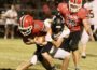 North Mahaska’s Kaleb Stout digs for yards as Eddyville-Blakesburg-Fremont’s Thomas McCrea holds on. Stout rushed for 64 yards to help NM to a 22-6 victory over the Rockets in the season opener Friday.