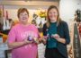 Judy Groenendyk of Brushed by Jude (left) and Amanda Doud from Mahaska Health Foundation (right) pose with some examples of painted rocks, similar to what will be made by participants.