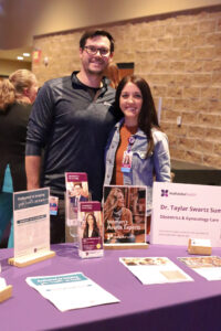 Dr Garth Summers, OB/GYN Physician, and Dr. Taylar Swartz Summers, OB/GYN Physician, at the Mahaska Health Community Health Fair September 2023. Photo Credit: Sarah Hoy Photography.