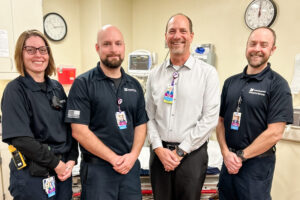 Mahaska Health Emergency Services Medical Director Matthew Gritters, MD (white shirt) with emergency room staff. (Mahaska Health Photo)