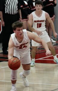 Ryan Andersen pulls down a rebound and races toward a basket against BGM as teammate Nate Sampson looks on. Andersen scored 20 points in an 88-35 win over the Bears.
