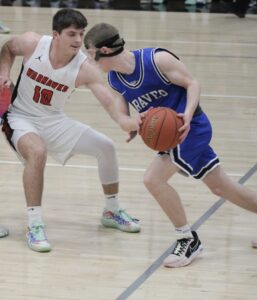 RD Keep/NM Communications North Mahaska’s Nate Sampson clamps down on Montezuma’s Brady Boulton in the first half. Sampson limited the Braves’ leading scorer to 16 points and scored 20 od his own to guide NM past Montezuma 46-42 to advance the Class 1A District 10 final.