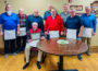 Bob Jones (seated) received a document commemorating his 75 years with Mahaska County Lodge 644.