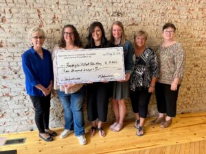 Members of Mahaska County Community Foundation present a $5000 grant award to Friends of Stilwell Public Library of New Sharon. Pictured from left to right are Margaret Ratcliffe, Christy Bellinger, Alexa Stout, Josie Davis, Vicky Collette, and Madonna Bowie. 