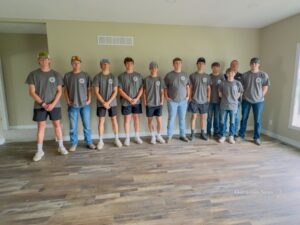 Members of the Oskaloosa Buildings and Trades program stop for a group picture at their most recent open house.