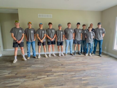 Members of the Oskaloosa Buildings and Trades program stop for a group picture at their most recent open house.