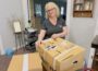 Sheila Guiter is seen here packing up donations from their current location for storage.