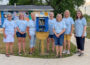 The International Altrusa Club of Oskaloosa held a dedication ceremony for a new Little Free Library on Tuesday, June 25, 2024, at 6:00 p.m. The event took place at the Edmundson Park Playground and was aimed at promoting literacy within the community.
