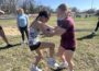 Oskaloosa High School girls track athletes practice self-defense techniques with each other during a hands-on training led by Navy SEAL veteran Clay Grandia. The session focused on building confidence, awareness, and practical skills to help students protect themselves in real-life situations.