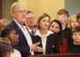 Mike McGrory, left, superintendent of the Ottumwa Community School District, thanked Gov. Kim Reynolds as she signed into law a bill setting a statewide minimum ban on cellphones during instructional time at public K-12 schools. (Photo by Robin Opsahl/Iowa Capital Dispatch)