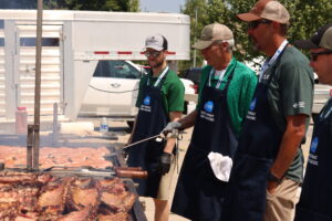  Volunteers flip pork chops and ribs at the Iowa State Fairgrounds during the World Pork Expo June 4, 2025. (Photo by Cami Koons/Iowa Capital Dispatch) 