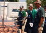 Volunteers flip pork chops and ribs at the Iowa State Fairgrounds during the World Pork Expo June 4, 2025. (Photo by Cami Koons/Iowa Capital Dispatch)
