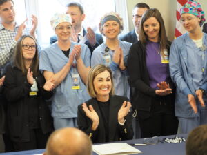  Gov. Kim Reynolds signed two healthcare bills into law at the Guthrie County Hospital in Guthrie Center May 28, 2025, including her proposal to increase rural health care accessibility. (Photo by Robin Opsahl/Iowa Capital Dispatch)