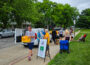 Volunteers and families gather outside of the College Avenue Friends Church, one of the pick up locations this summer, to pick up meal packets during the Oskaloosa Schools Summer Meal Program, which provided more than 102,000 meals to local children this year.