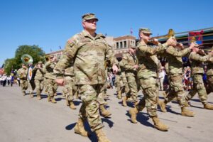 Iowa National Guard members will be deployed to assist federal immigrant enforcement efforts, Gov. Kim Reynolds announced Aug. 12, 2025. Guard members are shown here marching in a parade at the Iowa State Fair. (Photo courtesy of Iowa National Guard)