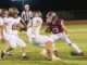 Oskaloosa quarterback Tyler Edgar scrambles from Mt. Pleasant defenders on Friday night.