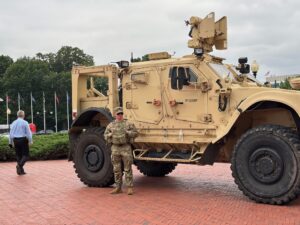 A member of the National Guard stands alongside a military vehicle parked in front of Union Station, near the U.S. Capitol in Washington, D.C., on Aug. 18, 2025. (Photo by Jane Norman/States Newsroom)
