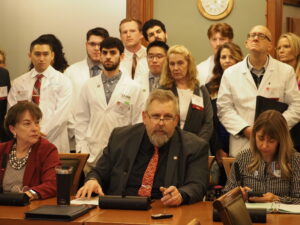  Sen. Mike Klimesh, joined by Sens. Annette Sweeney, left, and Sarah Trone Garriott, right heard public comments on a bill related to pharmacy benefits managers Feb. 5, 2025. (Photo by Robin Opsahl/Iowa Capital Dispatch)