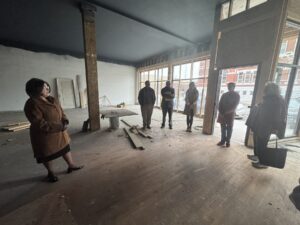 Debi Durham, director of the Iowa Economic Development Authority and Iowa Finance Authority, tours businesses around the Oskaloosa Square on Thursday, visiting active storefronts such as Spirit Cafe, the Book Vault, Hunter’s Gift and Coffee Café’s, and Brown’s Shoe Fit, as well as emerging projects including Hunter’s upper-story housing concept and the construction site of the new Jaarsma Bakery. Durham’s afternoon visit highlighted Oskaloosa’s momentum in Main Street revitalization and ongoing downtown investment.