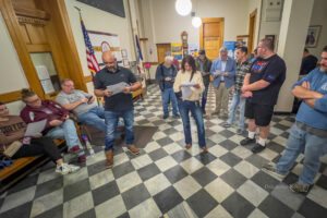 Candidates and community members process the voting results on Tuesday night after an extensive delay in reporting. Toubekis read the results aloud to those gathered.