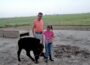 Emma Yerkey and her dad, Tim Yerkey, with the ribbon-winning calf they raised together. (Photo courtesy of Emma Yerkey)