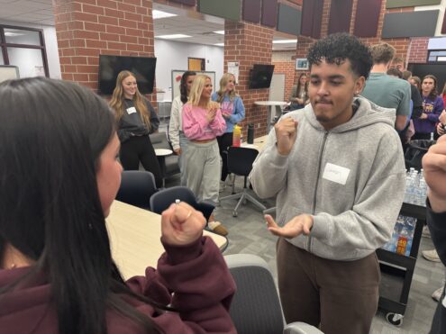 Students from across the Hawkeye Conference work together on posters and cheer one another on during a conference-wide rock-paper-scissors competition, part of a student section training focused on sportsmanship, leadership and positive school spirit. Students also created a video on sportsmanship, produced by Oskaloosa Video Production students. The activities encouraged collaboration beyond school rivalries, reinforcing the shared expectation to cheer for one’s own team, respect opponents and create a welcoming atmosphere at athletic events.
