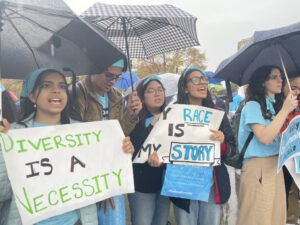  Harvard student Samaga Pokharel, right, with “My Race is My Story” sign, joined other students and supporters of affirmative action outside the U.S. Supreme Court Oct. 31, 2022, as it heard two cases that could reshape college admissions policies. (Photo by Ariana Figueroa/States Newsroom)