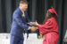 Oskaloosa School Board President Matt Sherlock congratulates a member of the Oskaloosa High School Class of 2026 while presenting diplomas during commencement ceremonies Sunday afternoon at the OHS gymnasium. (submitted photo)