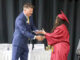 Oskaloosa School Board President Matt Sherlock congratulates a member of the Oskaloosa High School Class of 2026 while presenting diplomas during commencement ceremonies Sunday afternoon at the OHS gymnasium. (submitted photo)