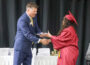 Oskaloosa School Board President Matt Sherlock congratulates a member of the Oskaloosa High School Class of 2026 while presenting diplomas during commencement ceremonies Sunday afternoon at the OHS gymnasium. (submitted photo)