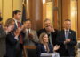Iowa Gov. Kim Reynolds, joined by Republican leaders in the state Senate and House, signed a measure into law May 18, 2026, aimed at lowering property taxes. (Photo by Robin Opsahl/Iowa Capital Dispatch)