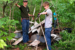 Wyatt DeCook, left, and a friend remove scrap metal and other discarded materials from a wooded area at Cedar Bluffs Natural Area near Oskaloosa. DeCook and several volunteers have removed more than 2,600 pounds of metal and debris from the conservation area in recent weeks.