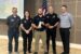 Oskaloosa Police Officer Logan Nord, center, holds the 2026 Iowa Association of School Resource Officers School Resource Officer of the Year award. Oskaloosa Police Chief Ben Boeke and Oskaloosa City Manager Shawn Metcalf are pictured to Nord’s left during the award presentation. Photo submitted.